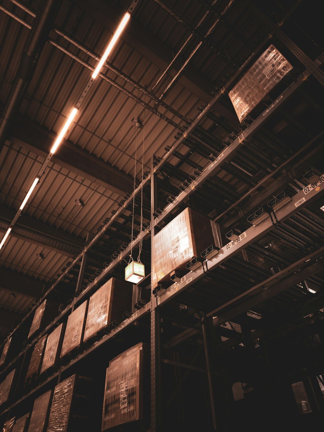 a-light-hanging-from-a-ceiling-in-a-warehouse-yi1maot4ybs
